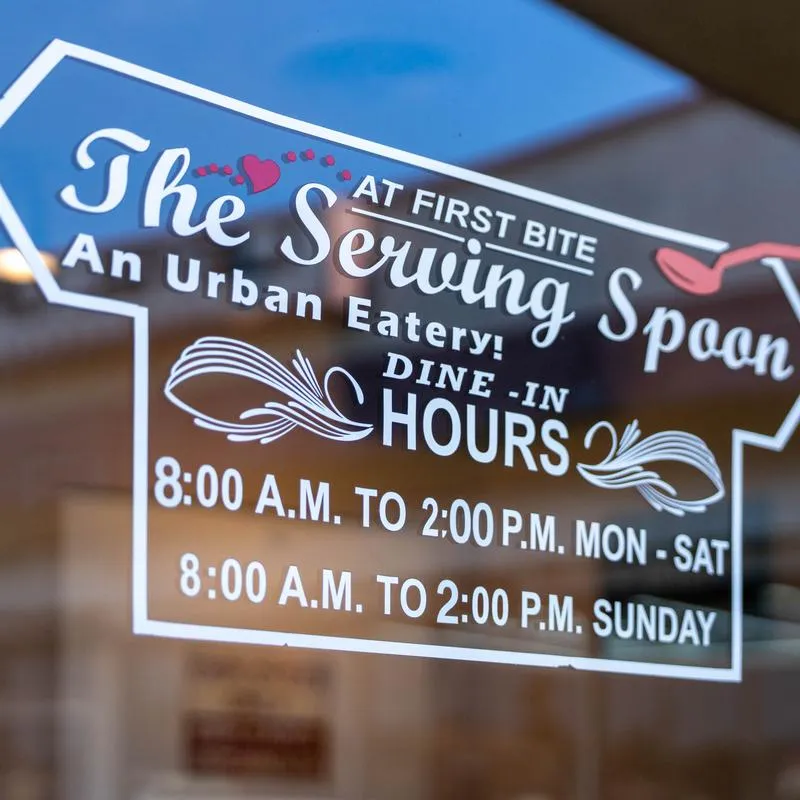 The Serving Spoon window sign showing hours of 8 AM to 2 PM